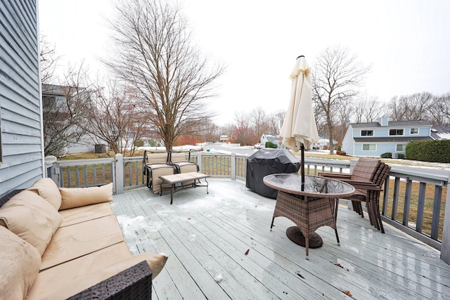 wooden deck with area for grilling and an outdoor living space