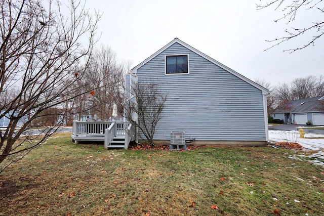 view of property exterior with a wooden deck, cooling unit, and a lawn