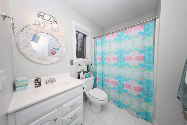 bathroom with toilet, tile patterned flooring, vanity, and a textured ceiling