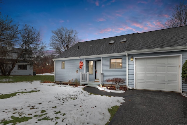 back house at dusk featuring a garage