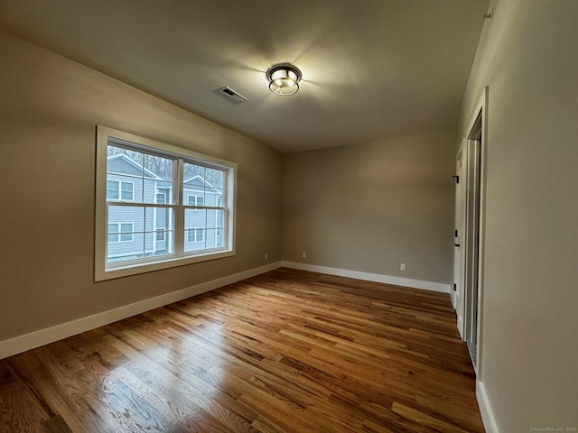 unfurnished room featuring hardwood / wood-style flooring