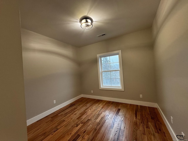 spare room featuring hardwood / wood-style flooring