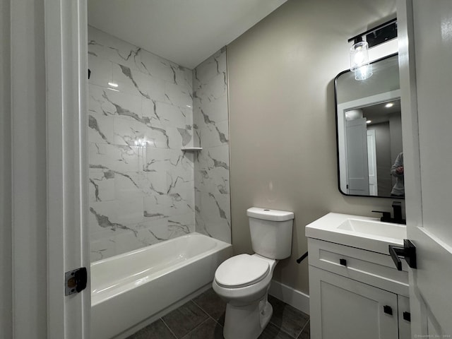 full bathroom featuring tiled shower / bath, vanity, and toilet