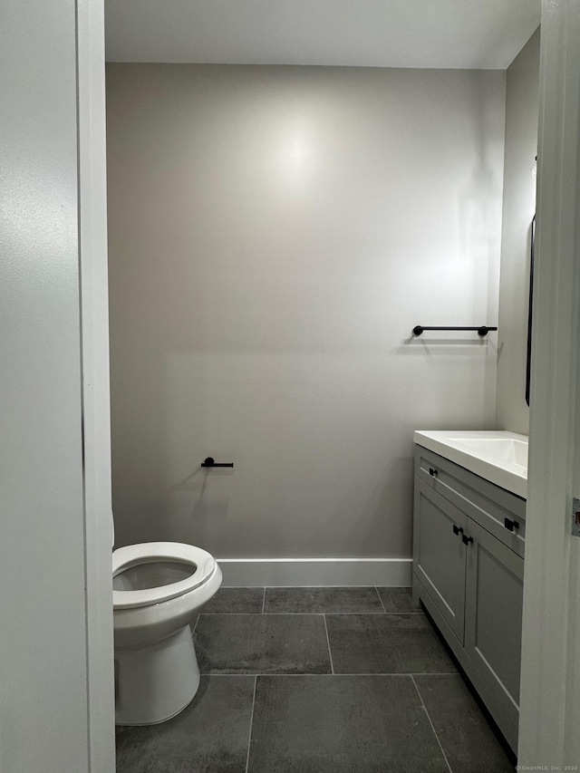 bathroom with tile patterned flooring, vanity, and toilet