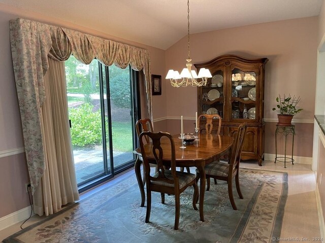 dining space featuring a chandelier and lofted ceiling