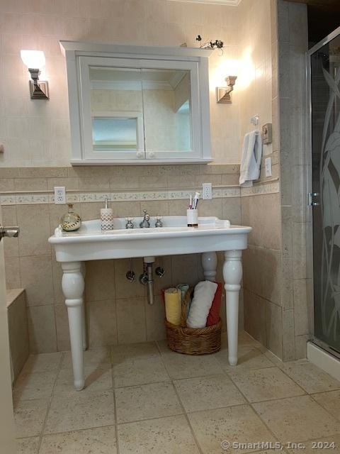 bathroom featuring walk in shower and ornamental molding