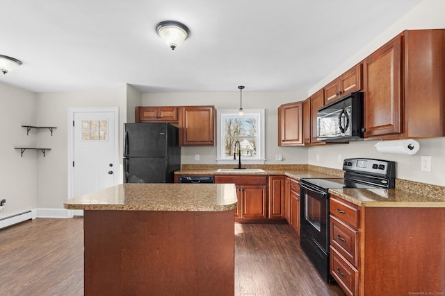 kitchen with dark wood-type flooring, black appliances, sink, decorative light fixtures, and a kitchen island