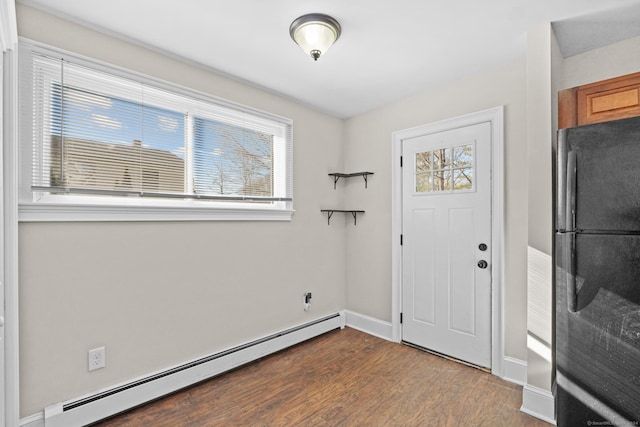 foyer with hardwood / wood-style floors and a baseboard radiator