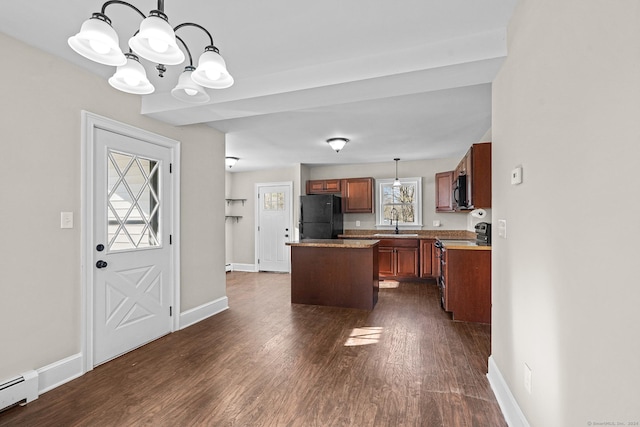 kitchen featuring baseboard heating, black appliances, a center island, dark hardwood / wood-style floors, and hanging light fixtures