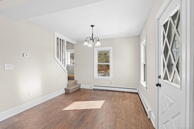 unfurnished dining area with a notable chandelier, baseboard heating, and dark wood-type flooring