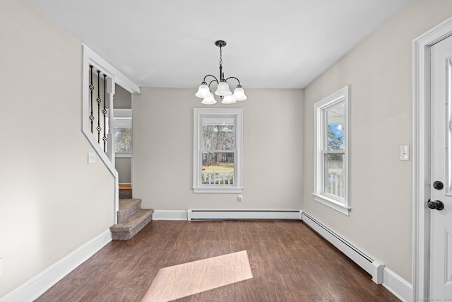 unfurnished dining area featuring dark hardwood / wood-style floors, an inviting chandelier, and a baseboard heating unit