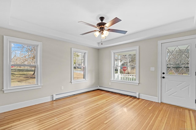 foyer with baseboard heating, ceiling fan, and light hardwood / wood-style floors