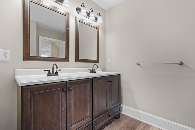 bathroom with vanity and hardwood / wood-style flooring