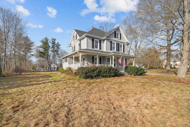 farmhouse with a front lawn and a porch