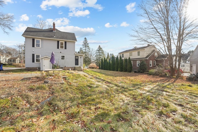 rear view of house featuring a lawn