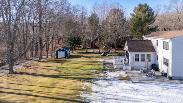 view of yard featuring a playground, a patio area, and a storage shed