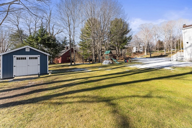 view of yard featuring a playground and a storage unit