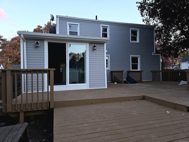 back of property with a wooden deck