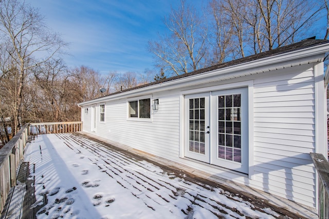 snow covered deck with french doors