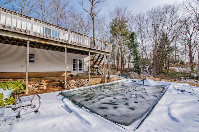 snowy yard featuring a deck