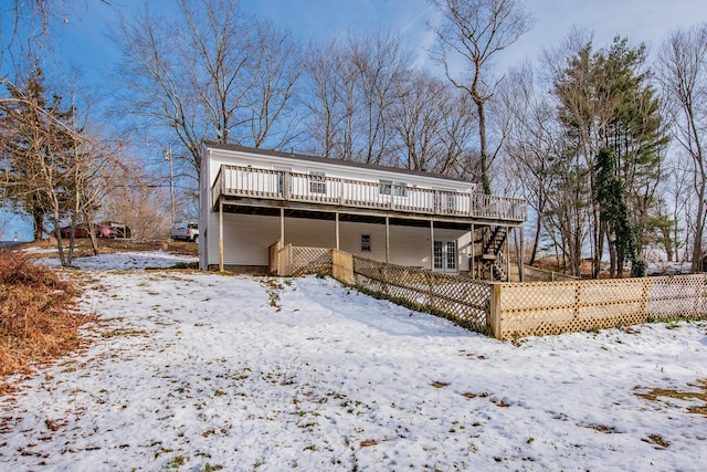 snow covered property featuring a wooden deck