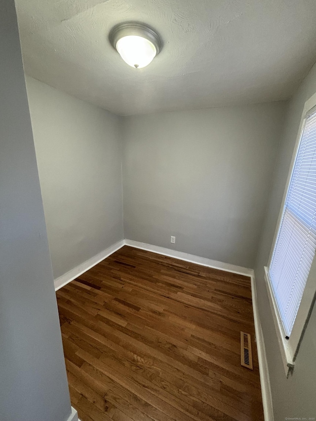 empty room with dark wood-type flooring