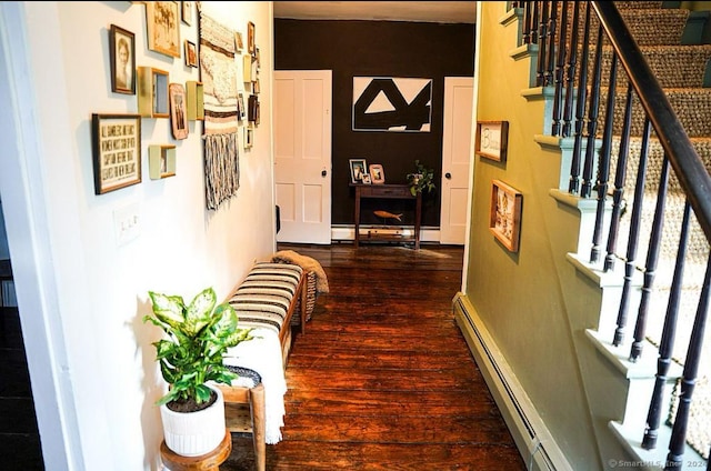 hallway featuring dark hardwood / wood-style floors and a baseboard heating unit