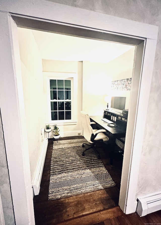 office area featuring dark wood-type flooring and a baseboard radiator