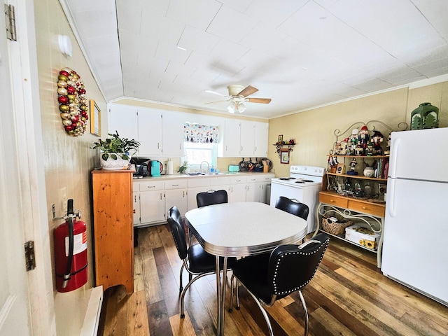 dining room with ceiling fan, washer / clothes dryer, dark wood finished floors, and ornamental molding