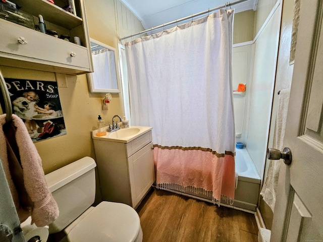 bathroom featuring toilet, wood finished floors, vanity, and shower / bathtub combination with curtain