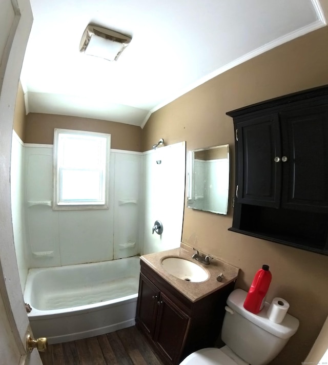 bathroom with toilet, shower / bath combination, wood finished floors, and vanity