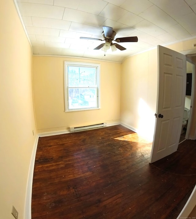 unfurnished room featuring dark wood-style floors, crown molding, a baseboard heating unit, ceiling fan, and baseboards