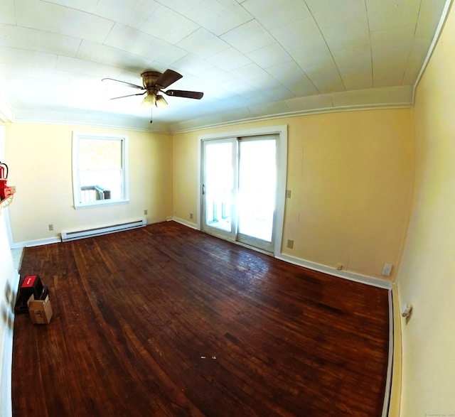 unfurnished room featuring a baseboard heating unit, wood finished floors, a ceiling fan, baseboards, and crown molding