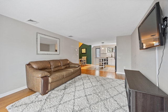 living room with light hardwood / wood-style flooring