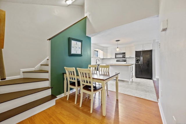 dining space with light hardwood / wood-style floors