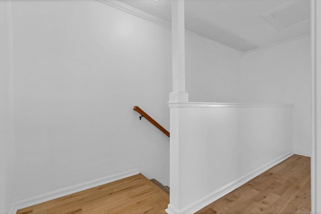 stairs with hardwood / wood-style flooring and crown molding