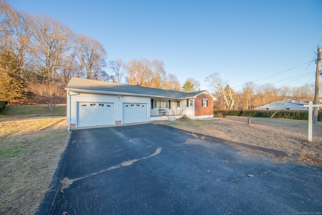 ranch-style home with a front yard and a garage