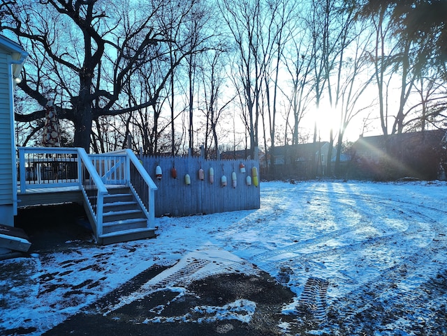 yard layered in snow featuring a wooden deck