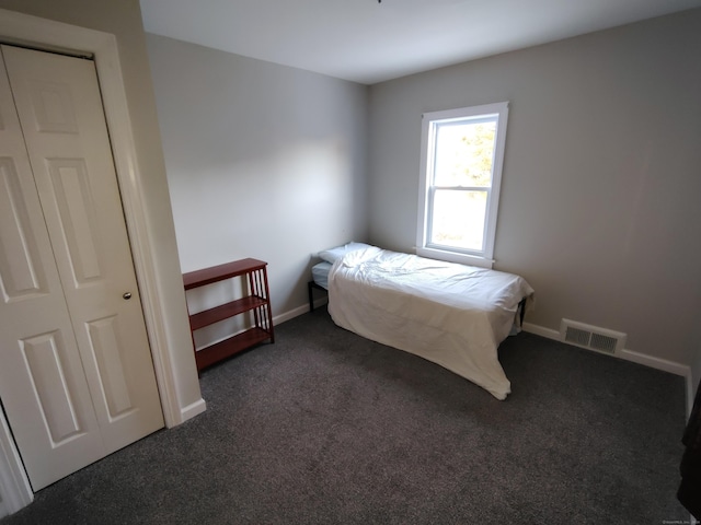 carpeted bedroom with a closet