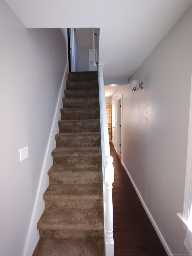 stairs featuring hardwood / wood-style floors