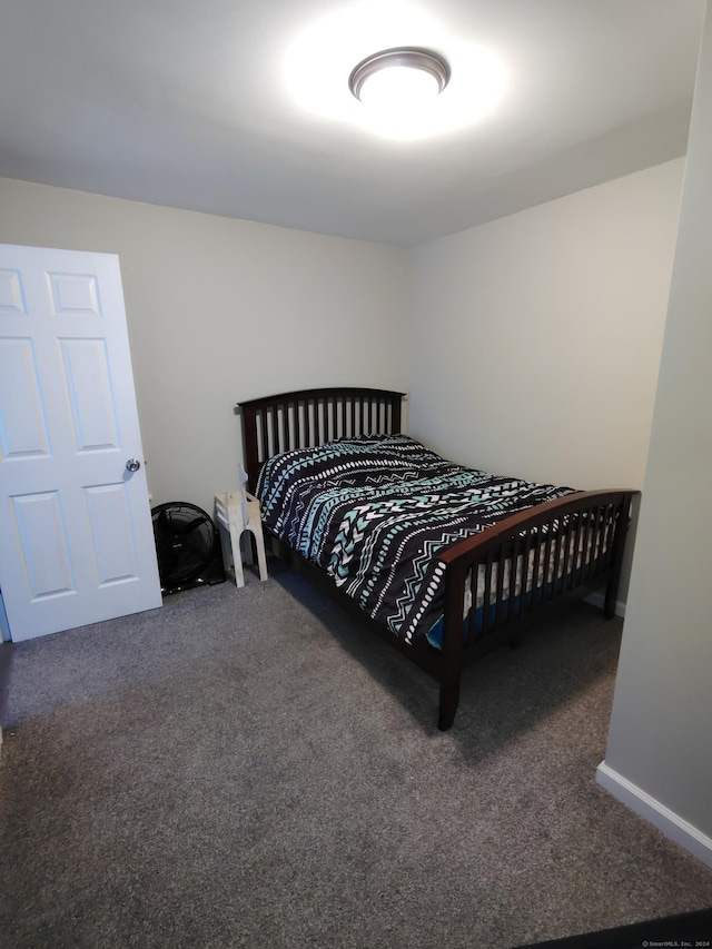 bedroom featuring dark colored carpet