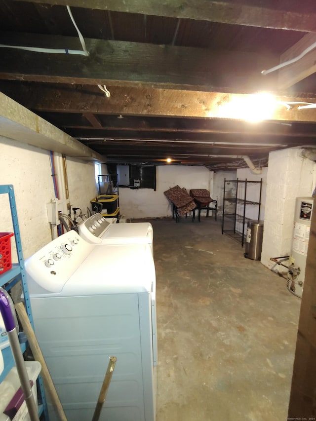 basement with electric panel, water heater, and washing machine and clothes dryer