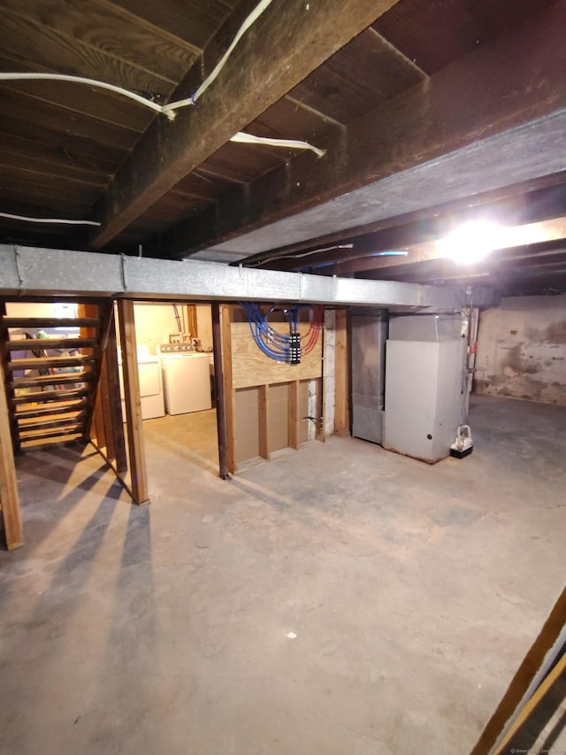 basement with heating unit and washing machine and clothes dryer