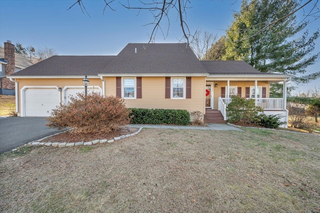 ranch-style house featuring a porch, a garage, and a front lawn