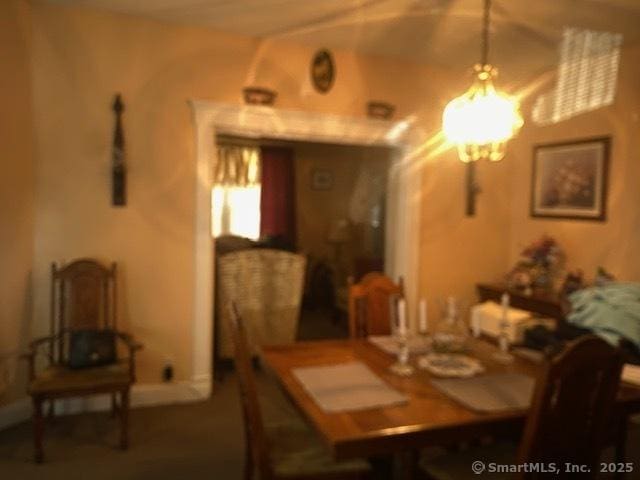 dining space with an inviting chandelier