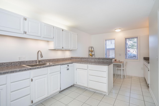 kitchen with sink, light tile patterned flooring, kitchen peninsula, white dishwasher, and white cabinets