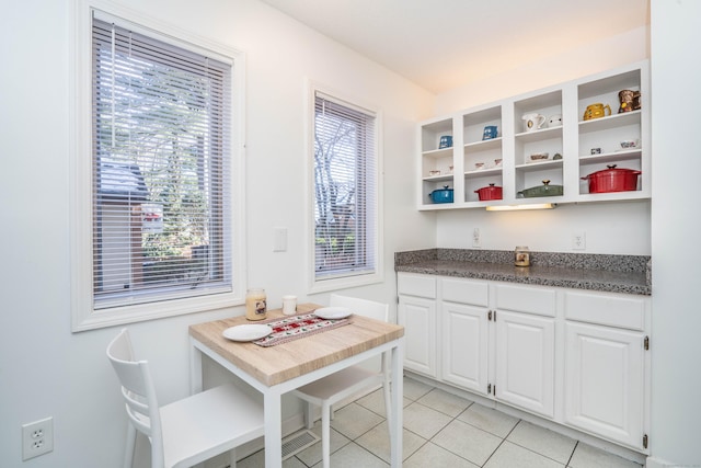 kitchen with white cabinets and light tile patterned flooring