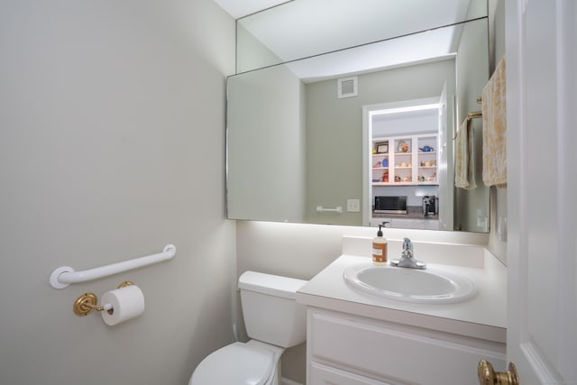 bathroom featuring vanity and toilet