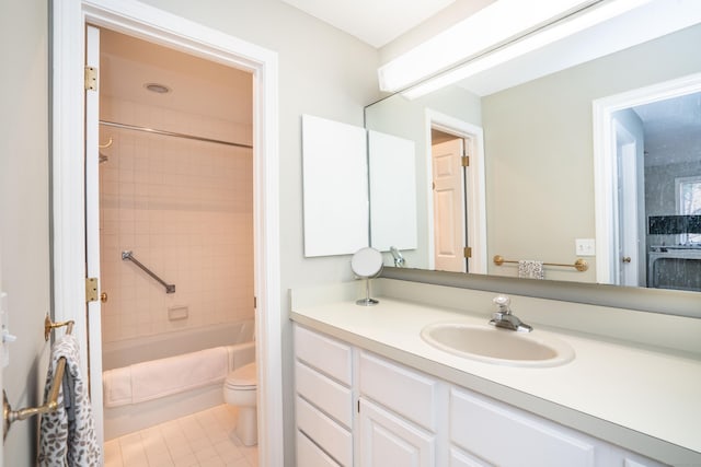 full bathroom featuring tiled shower / bath, tile patterned flooring, vanity, and toilet