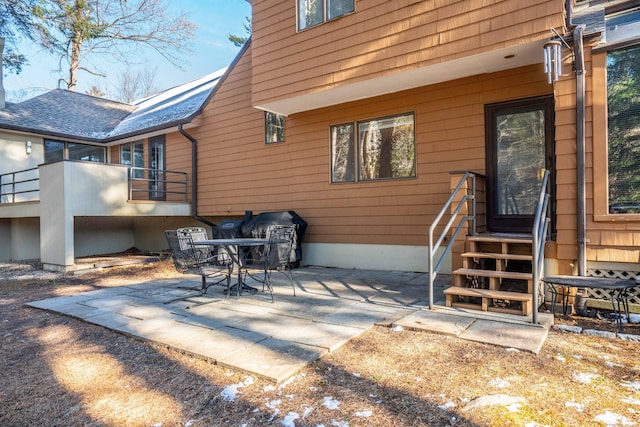 back of property with a patio